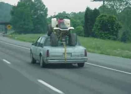 vehicle with ATV strapped to the top