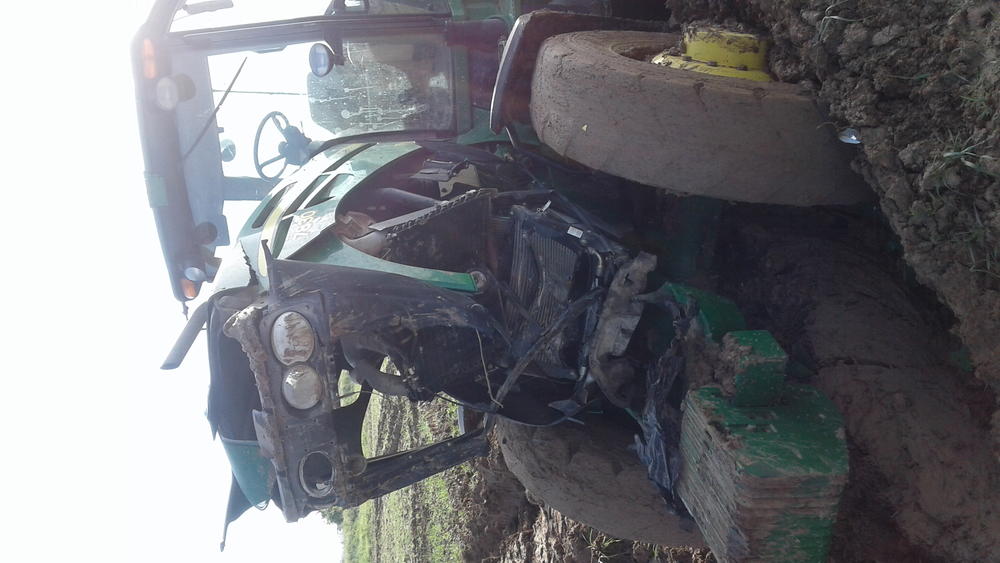 green tractor covered in mud