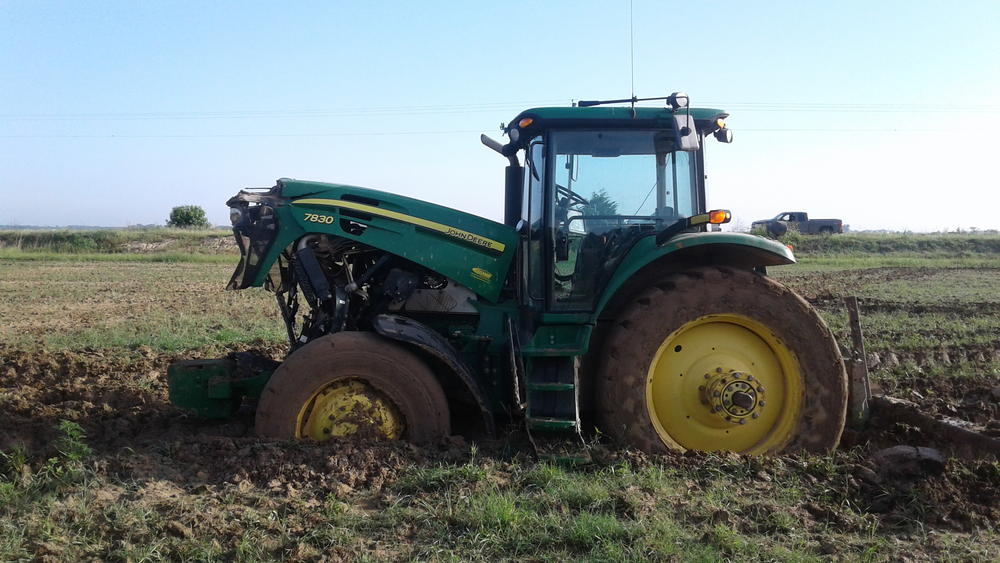 green tractor in field side view